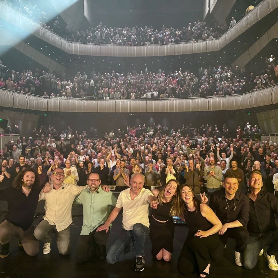 The band on stage in front of a full house